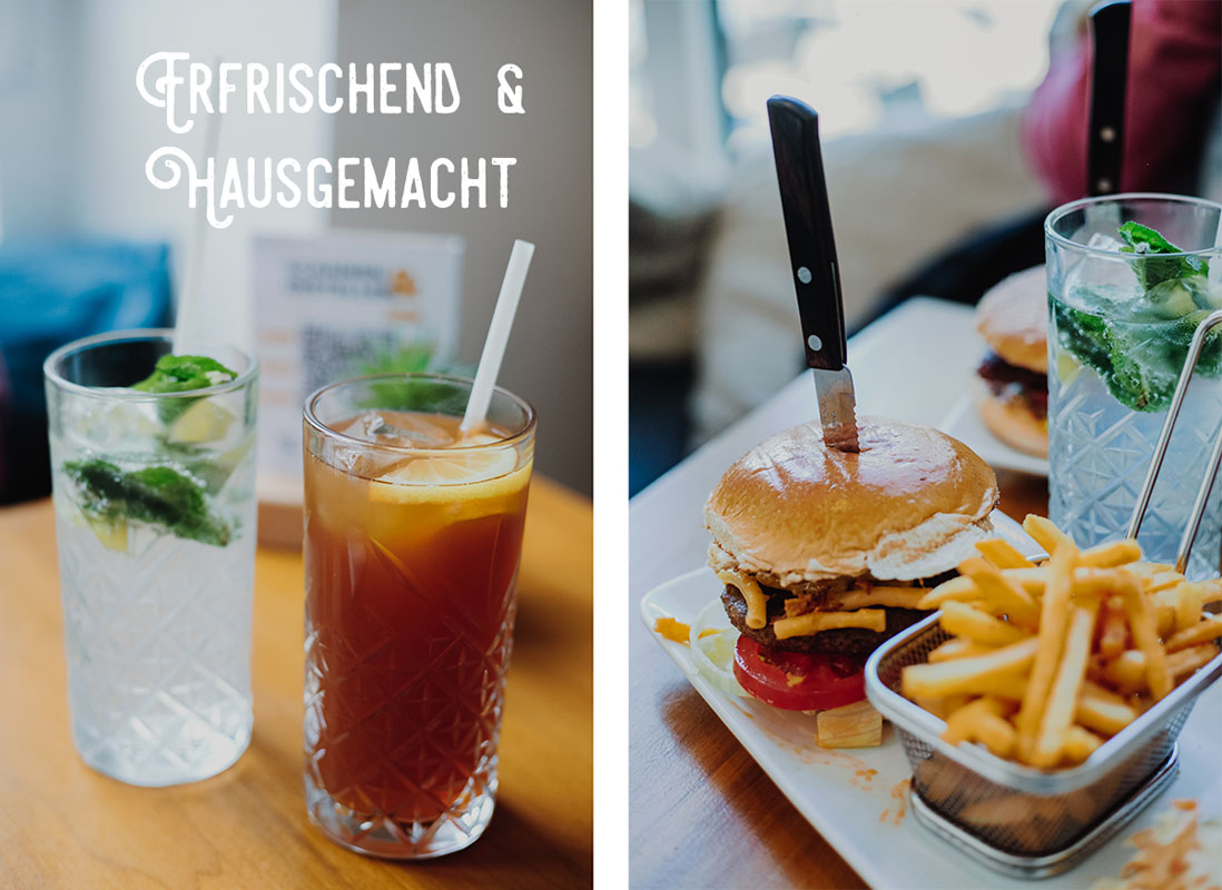 Zwei Limonaden im Glas und ein Teller mit veganem Burger und Pommes