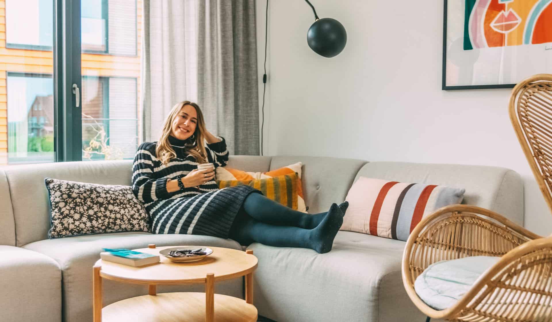 Finja sitzt in der Ferienwohnung auf der Couch